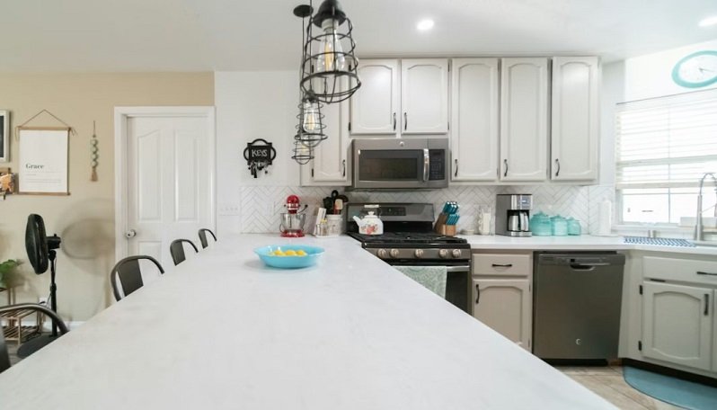 Beautiful and bright kitchen with a long dining table for tasting